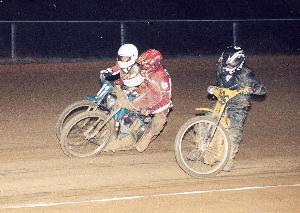 Alex Heath (r.) slides low while Dave Clark (c.) and